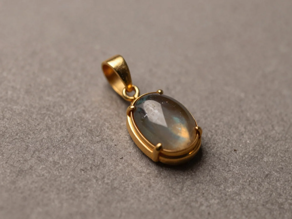 Macro studio still life of a pendant combining a gold setting, a